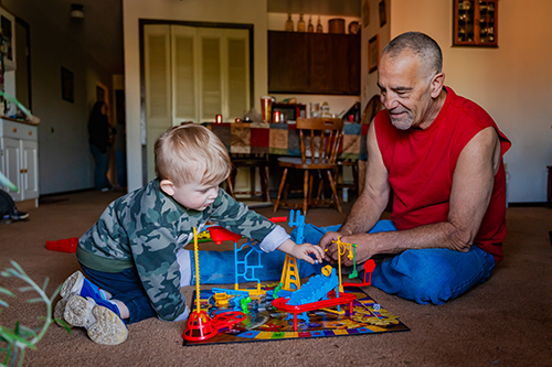 James Boelens playing with child